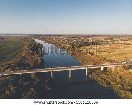 Aerial view of bridge over Don river in Voronezh, autumn landscape from above view with highway road and car transportation, toned