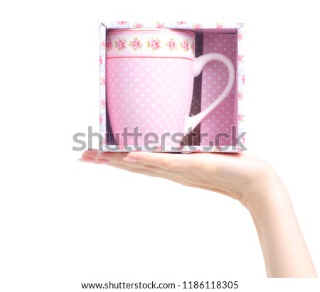 Cup mug vintage pink flower print box in hand on white background isolation