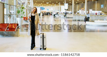 Website banner of young caucasian woman with valise walking in waiting hall at airport. Concept of blog header, heading and cheap tickets for traveling abroad, travel agency and business trips.