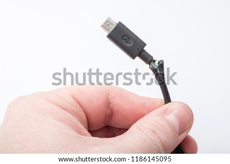 Broken usb cord for phone in hand on white background