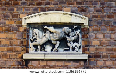 Ancient bas-reliefs on the Windows and walls of historical buildings. Architectural design elements from the past. Paris. Inspired by a monkey, a satire on human