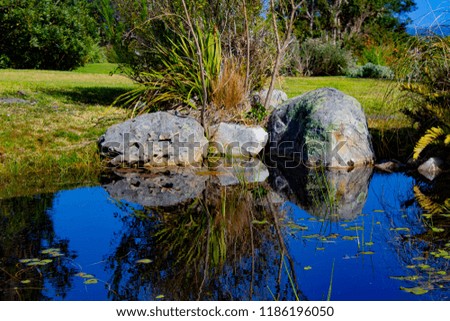 rocks reflecting on river bank 
