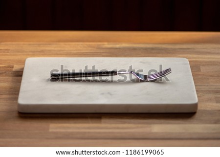 marble stone plate and fork on wooden table