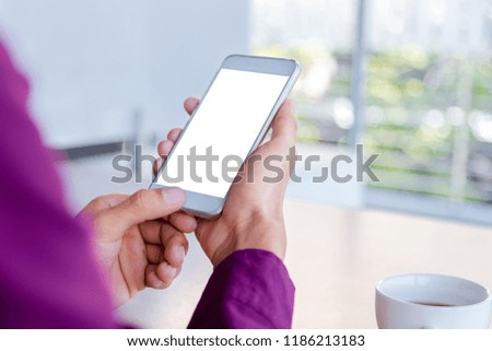 Mockup image of man's hands holding white mobile phone with blank screen technology and lifestyle concept.