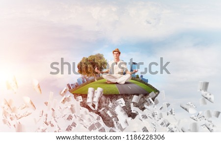 Man in white clothing keeping eyes closed and looking concentrated while meditating on island in the air among flying papers with cloudy skyscape on background. 3D rendering.