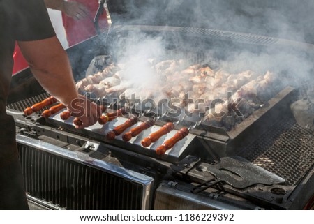 Meat grilled on skewers, brazier under the hood of the car