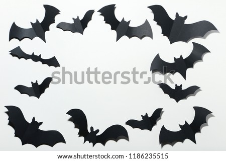 Halloween paper bats on white background