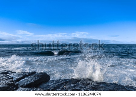 Sea with water splashes against cliffs, County Wexford, Ireland