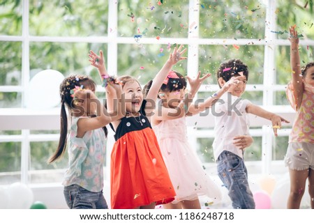 Happy birthday party Asian  children with Friendship  in confetti carnival or Celebration Party  birthday or  New Year Christmas Royalty-Free Stock Photo #1186248718