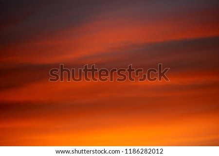 burning clouds in the evening sky after sunset Royalty-Free Stock Photo #1186282012