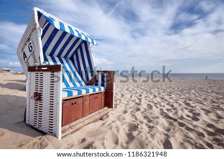 roofed wicker beach chair on baltic sea beach Royalty-Free Stock Photo #1186321948