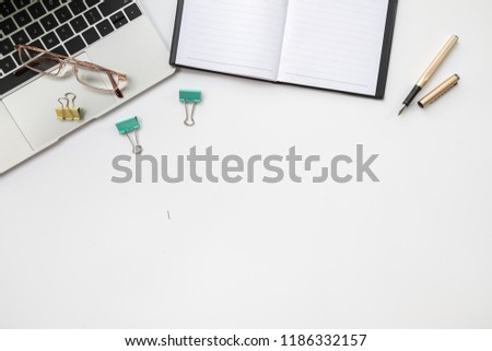 Office desk table with computer, supplies, ipad,smartphone,coffee cup on wooden background. Top view with copy space