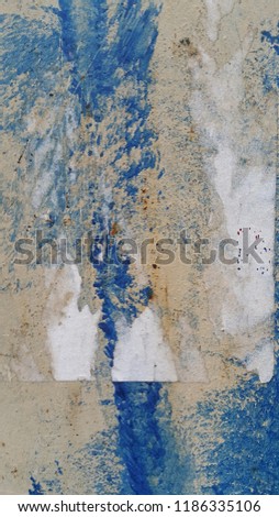 Weathered wall background consisting of worn out peeled spilled paints.