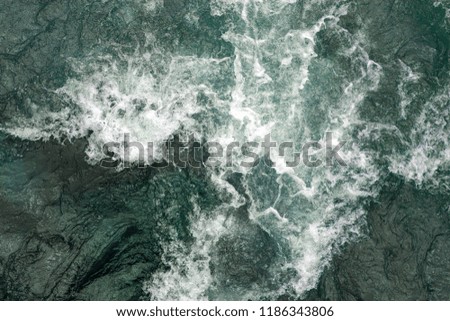 flow of water and spray from a stone close up