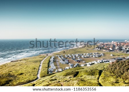 Camping with north sea ocean view with harbour overview on a bright summer day. Danish coastline, Hirtshals in North Jutland in Denmark, Skagerrak, North Sea Royalty-Free Stock Photo #1186353556