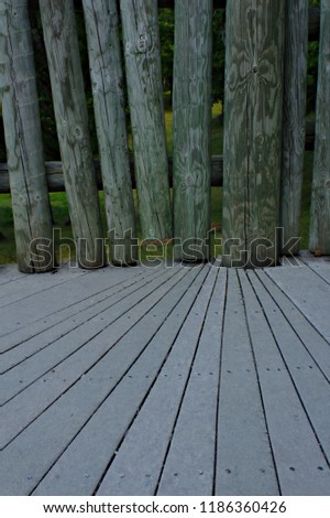 Perspective Background Texture of Smooth Lumber Deck Leading to Rustic Hewn Log Post Railing