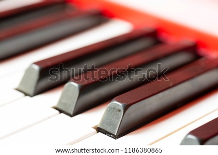 Vintage red classical grand piano. Black and white keys. The keyboard of antique key music instrument diagonal composition closeup 