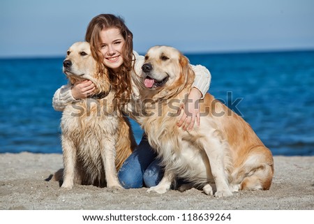 Beautiful girl with her dog  near sea