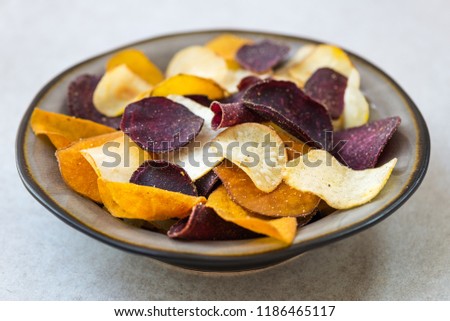 Bowl of Healthy Snack from Vegetable Chips, such as Sweet Potato, Beetroot, Carrot, Parsnip on Light Grey Background