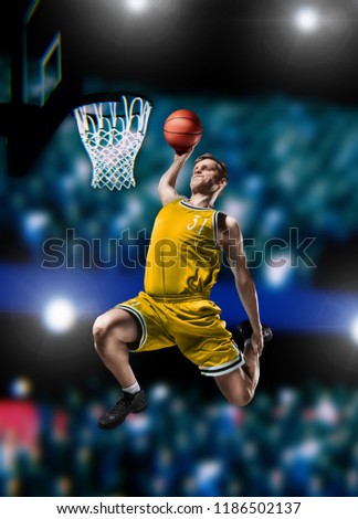 basketball player making slam dunk on basketball arena