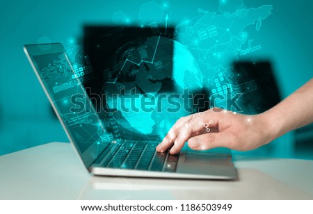 Hand using laptop with global reports and stock market change concept