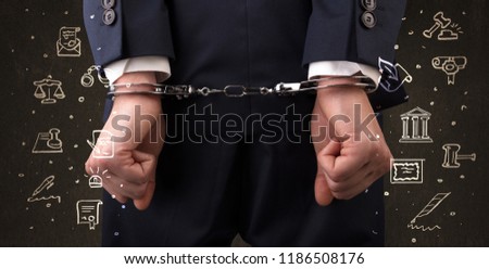 Chalk drawn courthouse symbols and close handcuffed hands in suit