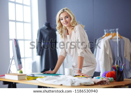 Fashion designer woman working on her designs in the studio.