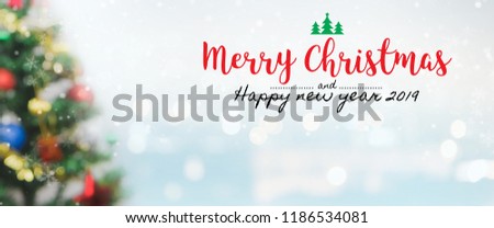 Christmas and Happy new year 2019 on blurred bokeh christmas tree banner background with snowfall.