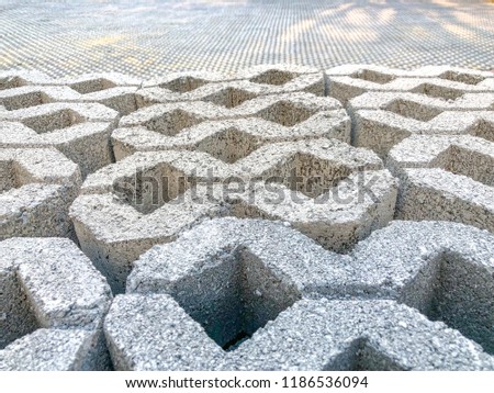 gray color stone brick block floor tile with green grass and sand as background or texture.