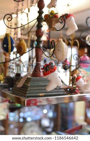 Christmas ornament display in an antique store.  Select focus on tiny vintage stocking.  Blurred background with some bokeh.