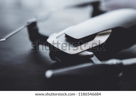 The concept of using drones in life and industry. Close up drone Engines and blades macro Details. Copy space. Innovation photography concept. Mate color. A new black drone on a black table.