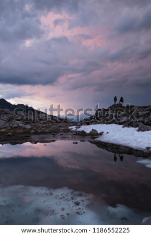 hikers viewing the setting sun in the North Cascade mountains in Washington State