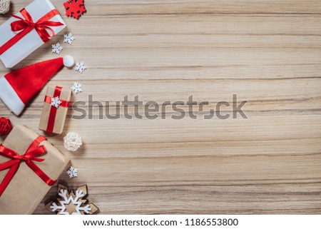 Christmas composition on rustic wooden background. Frame of pine tree toys and gift boxes. Mock up, copy space for your text. Top view, flat lay.

