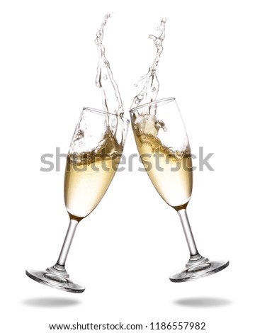 Cheers champagne with splashing out of glass isolated on white background. Royalty-Free Stock Photo #1186557982