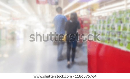 Shopping cart view in Supermarket aisle with Product shelves abstract blur defocused background
