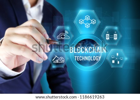 Businessman pointing blockchain icon on virtual screen,Blockchain technology concept,Elements of this image furnished by NASA
