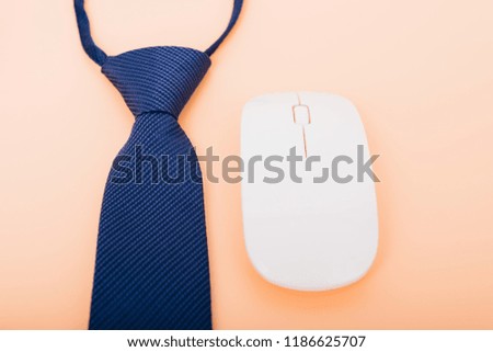 Top view business necktie and mouse on soft yellow desk table