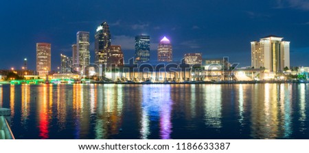 Night falls as lights come up on buildings beginning a beautiful summer evening in Tampa Florida downtown