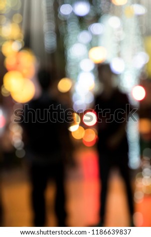 Conceptual abstract background image of defocused Christmas decoration on city street at night