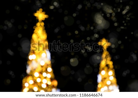 Conceptual background image of defocused abstract Christmas Tree on city street at night