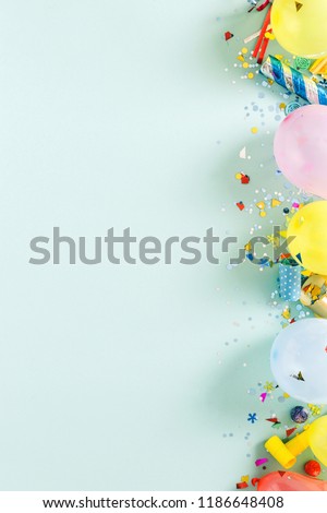 Flat lay decoration party concept on pastel blue background with border top view