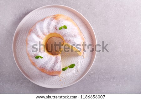 Lemon ring cake with icing sugar served on plate