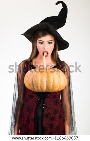 Attractive model girl in Halloween costume. Expression face - surprised woman. Happy young women in witch halloween costumes on party over white isolated background