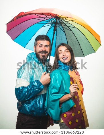 Couple wearing in autumn clothes. Surprised couple on autumn clothes discounts. Happy couple in love wearing in autumn clothes on autumn rain day