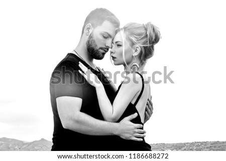 In love Eastern couple in mountains of Cappadocia hugs and kisses. Love and emotions loving couple vacationing in Turkey. Closeup portrait man and woman. Beautiful Crescent moon earrings on girl ears