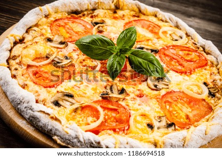 Pizza with ham, tomatoes and mushrooms 