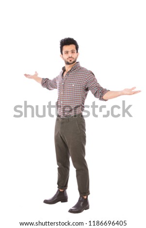 A full-length shot of a standing young man spread his arms as he challenge and say here I'm, isolated on a white background.