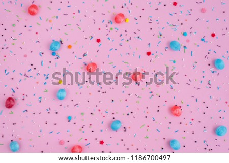 Round blue mint and red candies caramel on pink background.