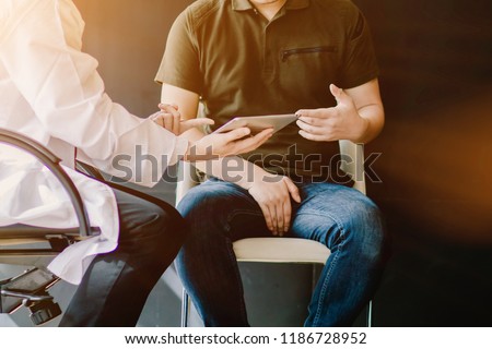 select Focus,The doctor is consulting with testicular cancer patients about testicular cancer tumors obtained from the lab so that the patient knows the symptoms and stage of testicular cancer Royalty-Free Stock Photo #1186728952