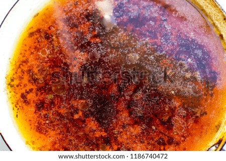 Stains of fat on the surface of water abstraction. Creative rough textured background.